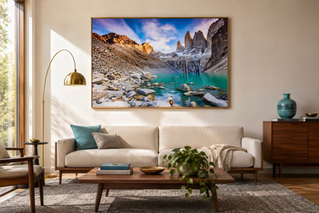 Patagonian cliff landscape canvas with turquoise lake and snow-capped peaks, framed above a sofa in a modern oak-floored living room.