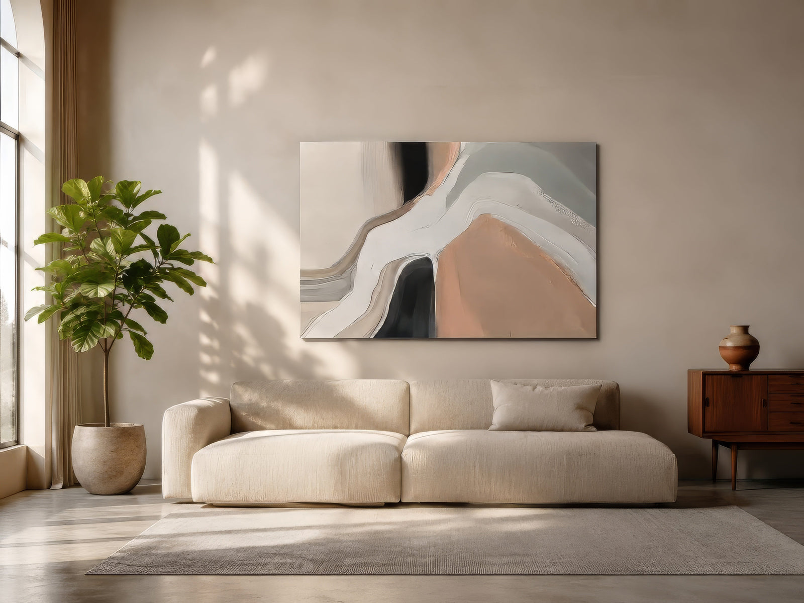 Neutral abstract canvas with blush, gray and black organic forms above ivory sofa in sunlit drawing room