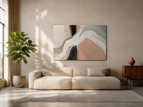 Neutral abstract canvas with blush, gray and black organic forms above ivory sofa in sunlit drawing room