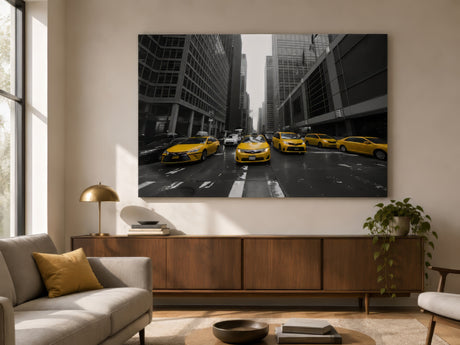 Selective-colour print of yellow cabs on a monochrome city street, framed above a walnut sideboard in a serene living room