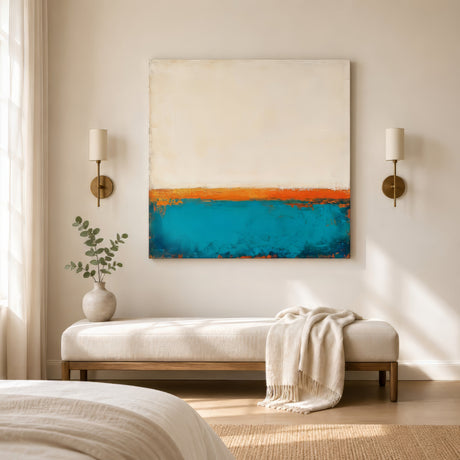 Ivory, orange, and turquoise abstract horizon canvas above a cream bench in a serene neutral bedroom.