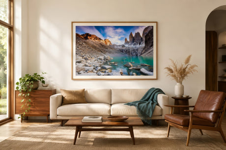 Torres del Paine mountain landscape print with turquoise lake in oak frame and cream mat, airy modern sunlit living room.