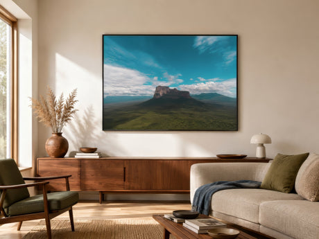 South American landscape canvas of Mount Roraima tepui in green and deep blue, framed above a linen sofa in a calm modern living room.