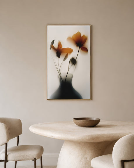 Blurred abstract floral canvas with amber poppies and dark silhouette vase, oak frame, neutral minimalist dining room.