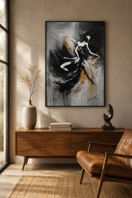 Abstract figurative painting of a dancing woman in black, white, and gold, framed above a walnut console in a warm modern entryway.