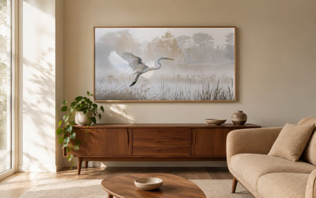 Misty marsh canvas of a white egret in flight over still water, framed above a wooden console in a serene neutral living room.