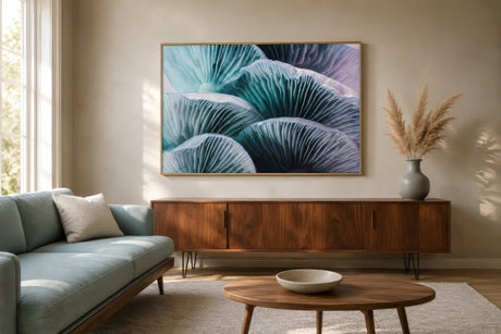 Oversized abstract floral wall art in teal, lavender, and ivory above a walnut console in a light-filled mid-century living room.