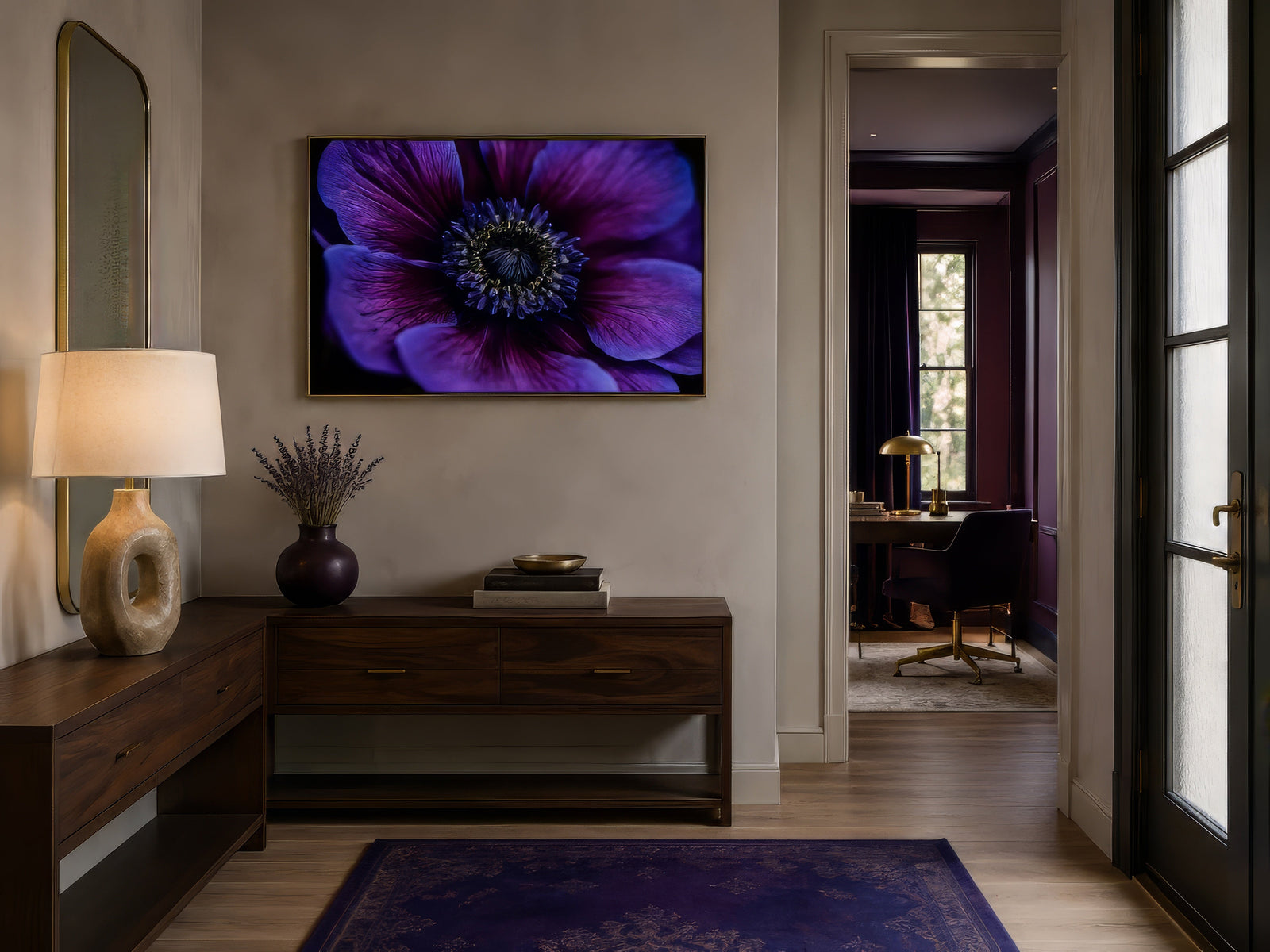 Macro anemone flower canvas in purple and magenta, framed in dark wood above a walnut console in a warm entryway.