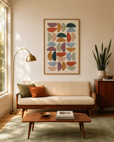 Mid-century geometric abstract wall art in mustard, teal, and burnt orange above a walnut sofa in a warm living room