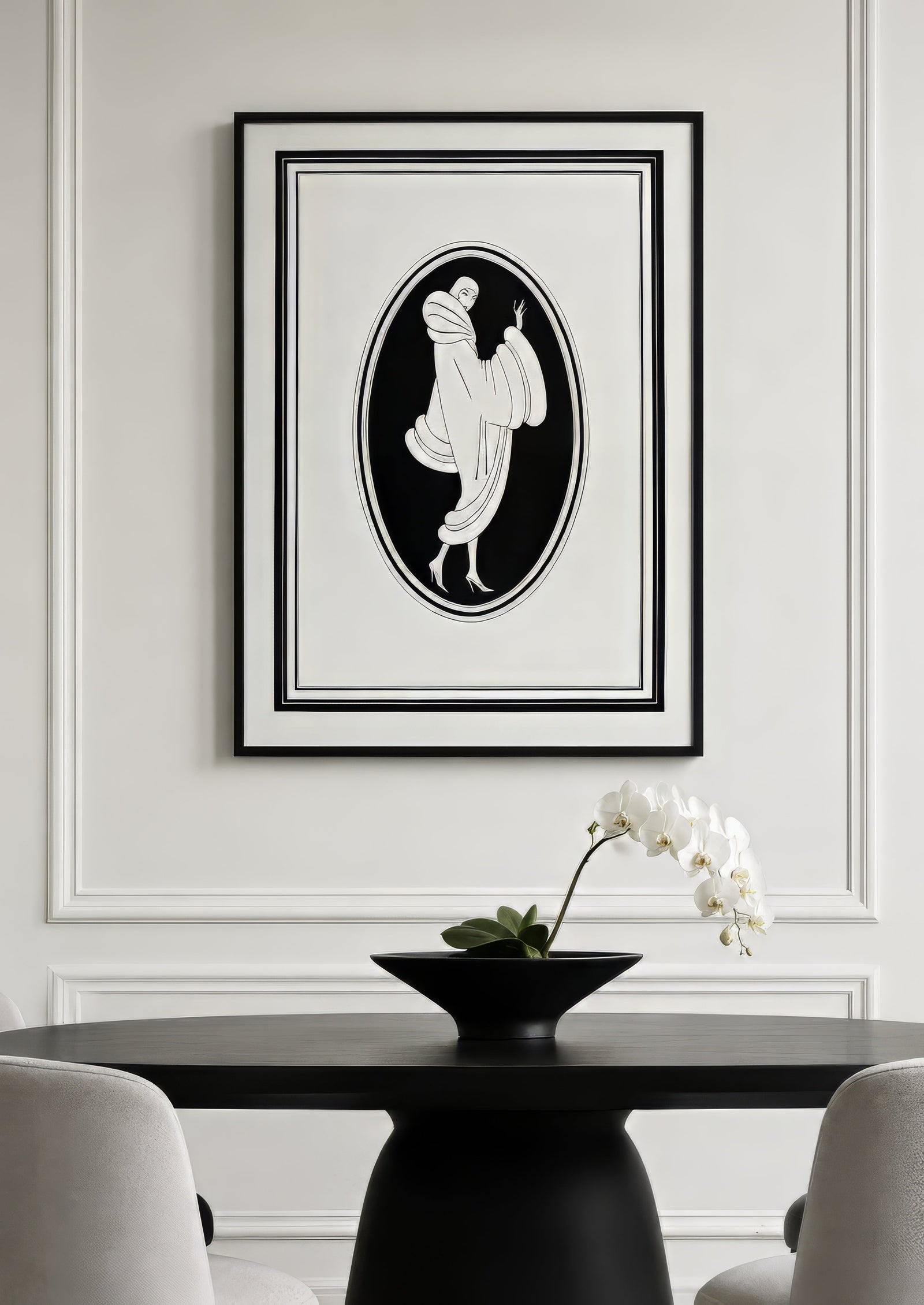 Black and white Art Deco draped figure print in oval composition, framed above a black dining table in an elegant neutral room.
