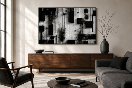 Black, white, and gray geometric line art canvas in a black frame above a walnut console in a calm small apartment living room.