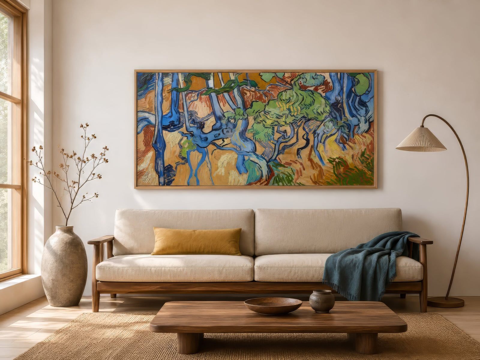 Post-impressionist tree roots painting in blue, green, and ochre, framed above a neutral sectional in a contemporary living room.