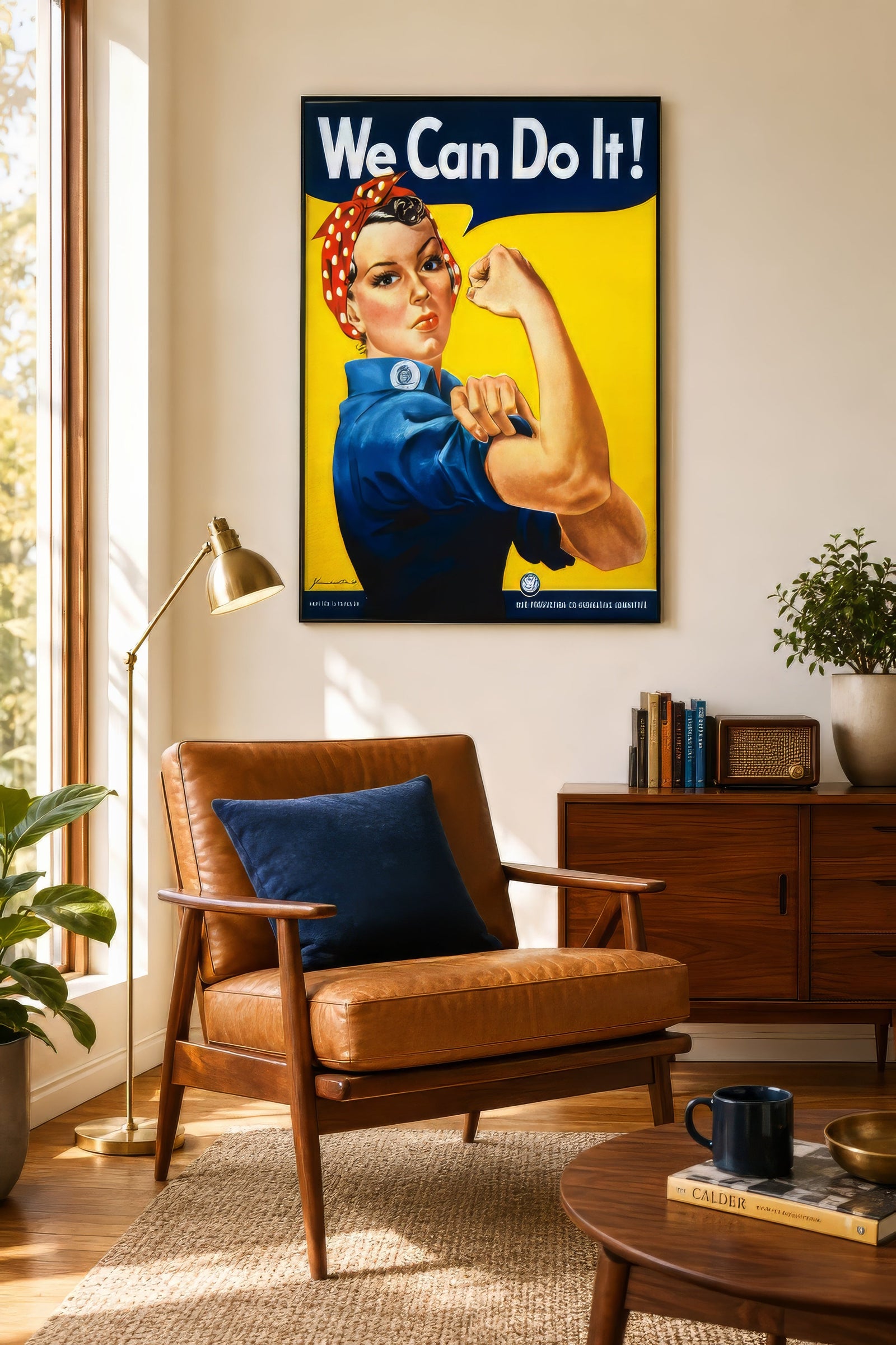 Vintage We Can Do It Rosie the Riveter poster in blue, red, and yellow, framed above a leather chair in a warm home office.