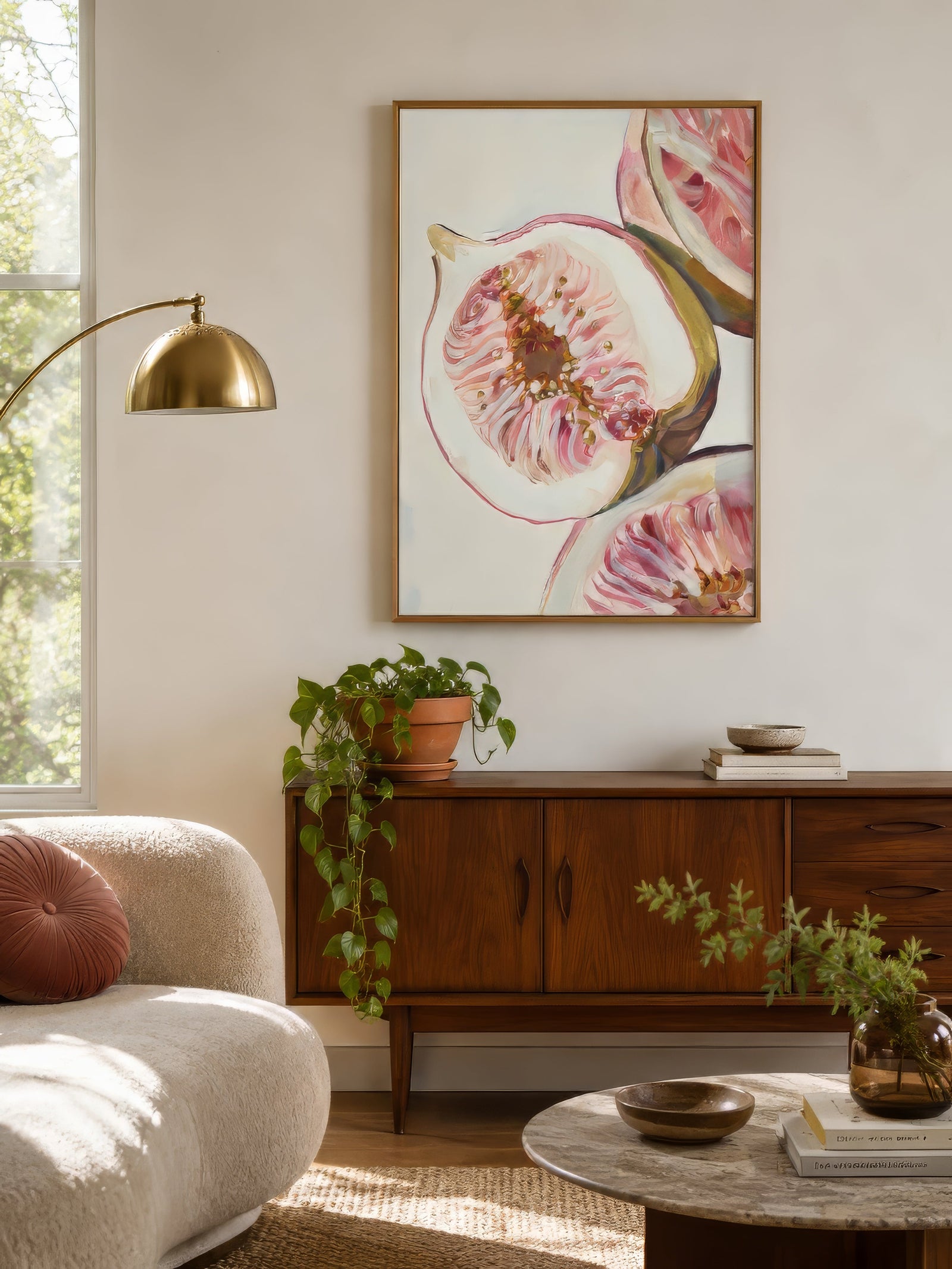 Painterly fig still life print in pink and ivory, framed above a walnut sideboard in a warm contemporary dining room.