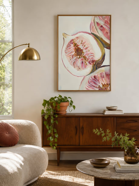 Painterly fig still life print in pink and ivory, framed above a walnut sideboard in a warm contemporary dining room.