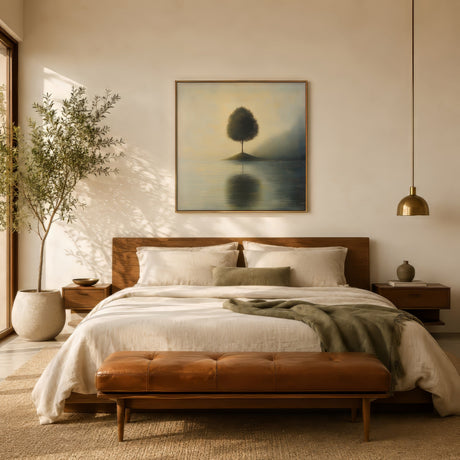 Misty lone tree and lake landscape print in soft gold and green, thin-framed above a linen bed for a restful bedroom.