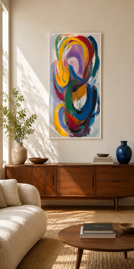 Vertical multicolor abstract canvas with swirling loops in purple, red, and gold over a mid-century console in a sunlit living room.