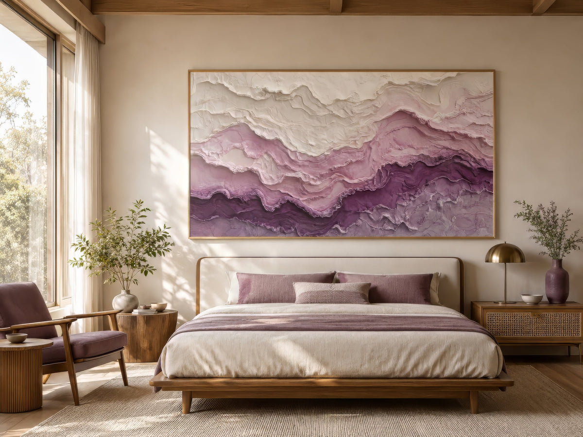 Purple and ivory textured abstract landscape canvas in a wood frame above a linen bed with wood nightstands, warm calm bedroom mood.