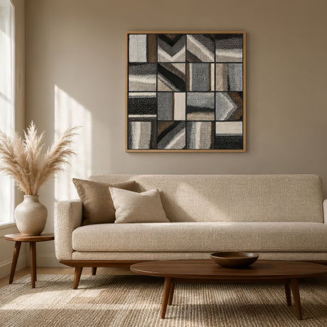 Geometric grid abstract canvas in taupe, charcoal and ivory, oak frame above a linen sofa in a serene neutral living room.