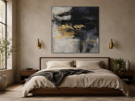 Neutral black, beige, and gold abstract canvas hung centered above a king bed in a warm luxurious master bedroom.