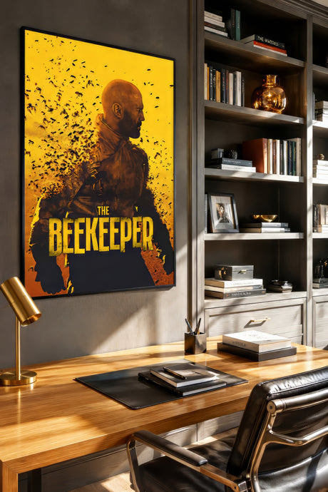 The Beekeeper vintage film poster in bold yellow, black, and amber, framed above a wooden desk in a moody home office.