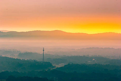 Arkansas wall art featuring mountainous landscape, orange dusk afterglow, and atmospheric clouds