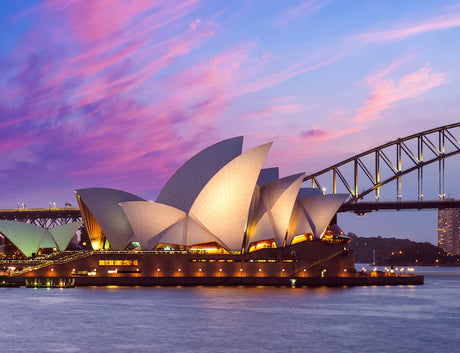 Sunset view of the Opera House and Tied-Arch Bridge at dusk, a popular tourist attraction in Australia