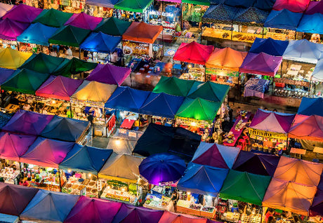 Night market festival scene in Bangkok, featuring retail tents at a lively bazaar
