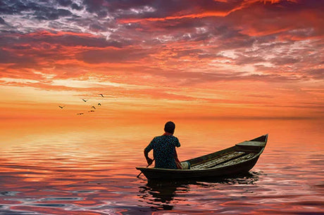 Bangladeshi wall art featuring a boat at sunset on the tranquil sea horizon
