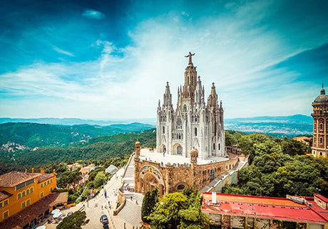 Panoramic bird's-eye view of Barcelona landmark, castle on hill station with tower and spire