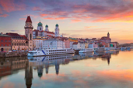 Bavarian cityscape wall art featuring a boat on a waterway, buildings, and water resources