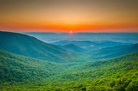 Sunrise over Blue Ridge Mountain landscape with afterglow and cloud-covered hills