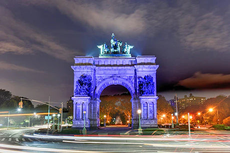 Brooklyn collection wall art featuring a night view of the Triumphal Arch illuminated by street lights