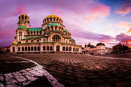 Bulgarian landmark basilica with Byzantine architecture, domes, and palace at dusk