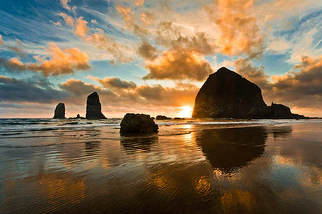 Dusk at Cannon Beach with coastal landforms, ocean waves and rock formations in wall art collection.
