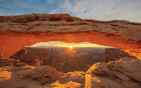 Stunning wall art featuring geological formations and natural arch in Canyonlands National Park