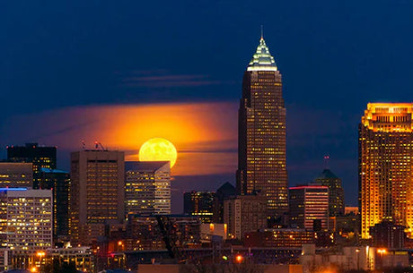 Dusk over Cleveland's urban skyline featuring high-rise buildings and iconic towers