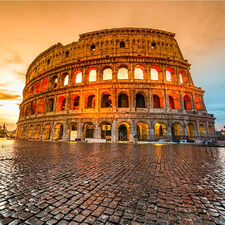 Colosseum wall art featuring Rome’s ancient amphitheater at sunset with glowing arches and cobblestone foreground — Colosseum Wall Art Collection for historic Italian decor.
