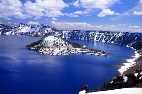 Crater Lake National Park with deep blue water, Wizard Island, and snow-covered caldera rim – dramatic nature wall art for rustic home or mountain retreat décor.