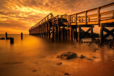 Delaware collection wall art featuring a sunrise, sea horizon, bridge, and pier at dusk.