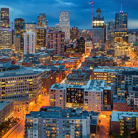 Illuminated downtown Denver skyline at twilight with modern skyscrapers and city lights – urban cityscape wall art for stylish home or office décor.