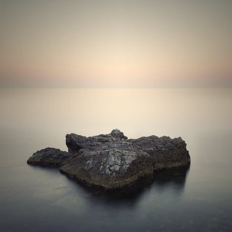 Minimalist landscape wall art featuring lone rock in calm sea at sunrise, soft neutral tones for serene modern home decor