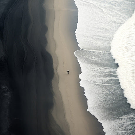 Fine art photography wall art of lone figure walking shoreline between ocean waves and dark sand, dramatic aerial beach print for modern decor