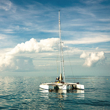 Catamaran sailing on calm turquoise waters under blue sky in the Florida Keys – peaceful coastal wall art for tropical home or ocean-inspired office décor.