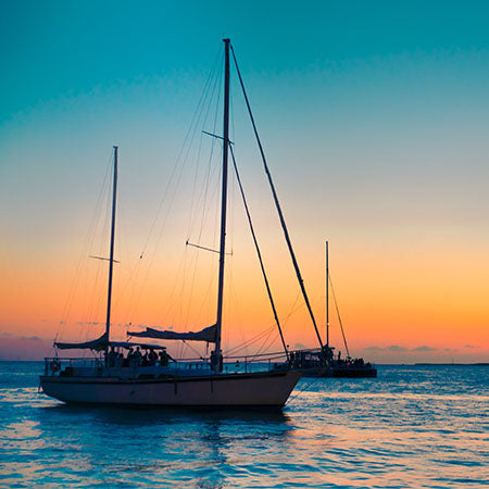 Sailboats on calm ocean at sunset off the Florida coast with vibrant sky – serene nautical wall art for coastal home or beach-inspired office décor.
