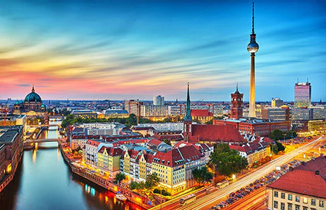 Evening cityscape of urban German metropolis with iconic tower, popular tourist attraction at dusk
