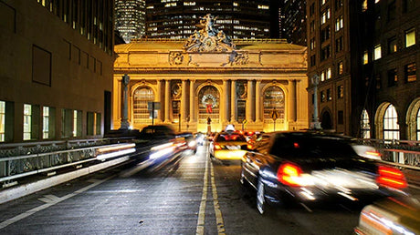 Nighttime wall art depicting Grand Central Station with city lights, cars, and bustling metropolitan streets.