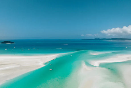 Caribbean island beach with boat on blue sea, part of Great Barrier Reef wall art collection