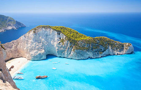 Beautiful Greece wall art featuring a tranquil blue ocean, coastal landforms, and prominent tourist attraction.