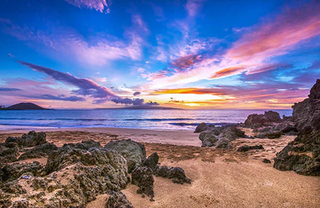 Stunning Hawaiian beach wall art featuring a crystal blue sky, azure water, and rocky coastline.